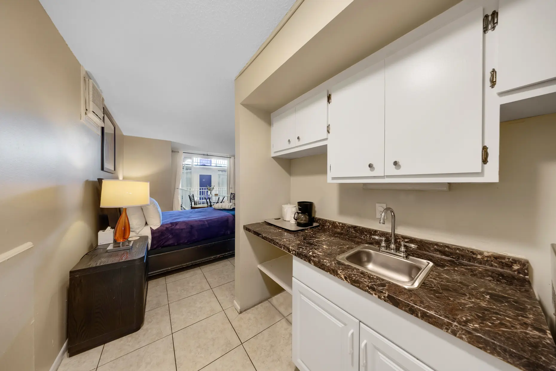 Deluxe room kitchenette with sink, coffee maker and microwave