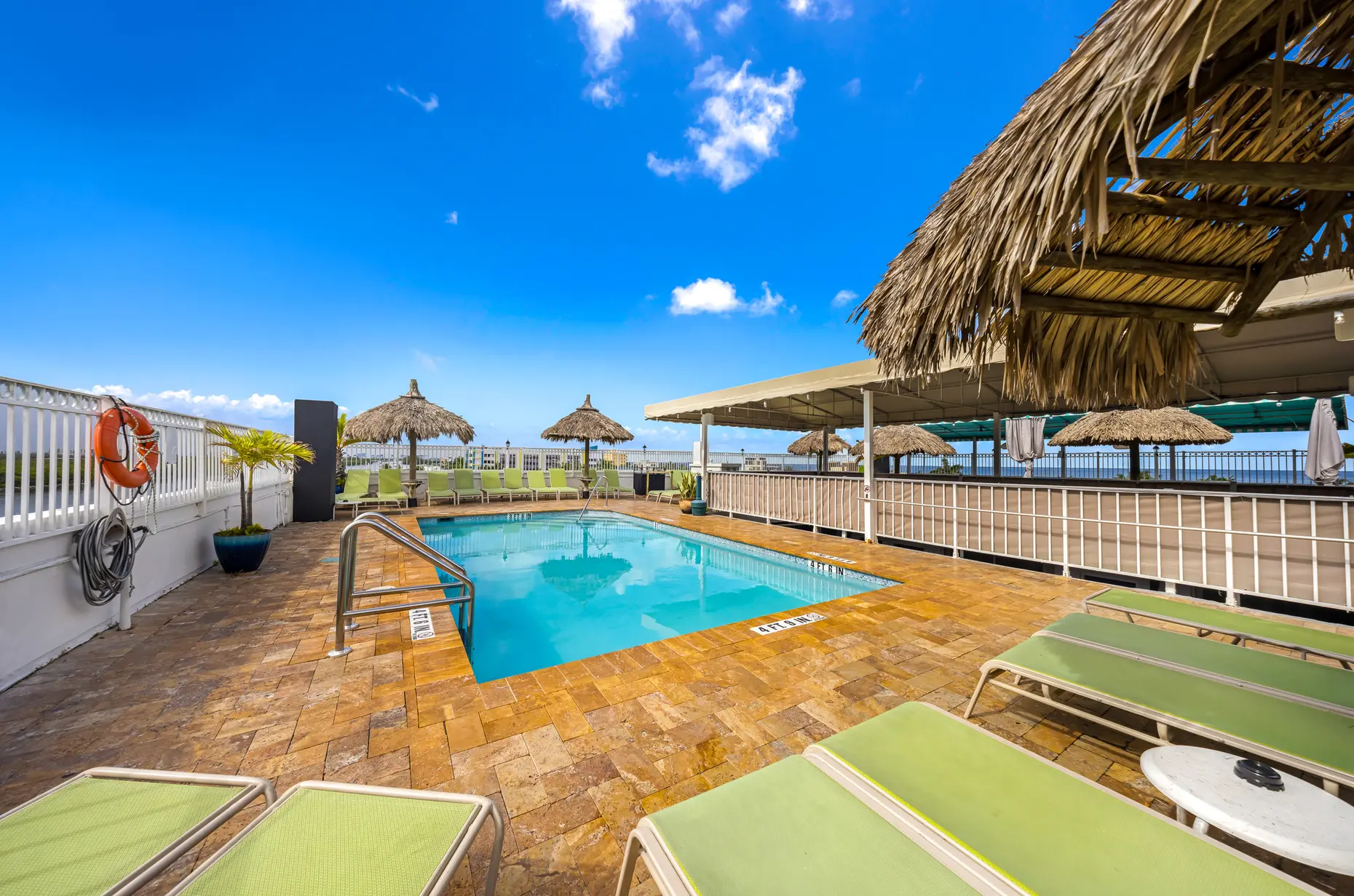 Rooftop pool and loungers in the sun