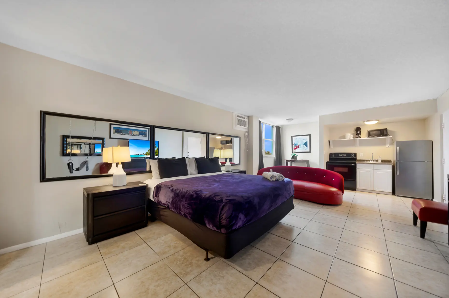 Swinging studio suite with king bed and red sofa